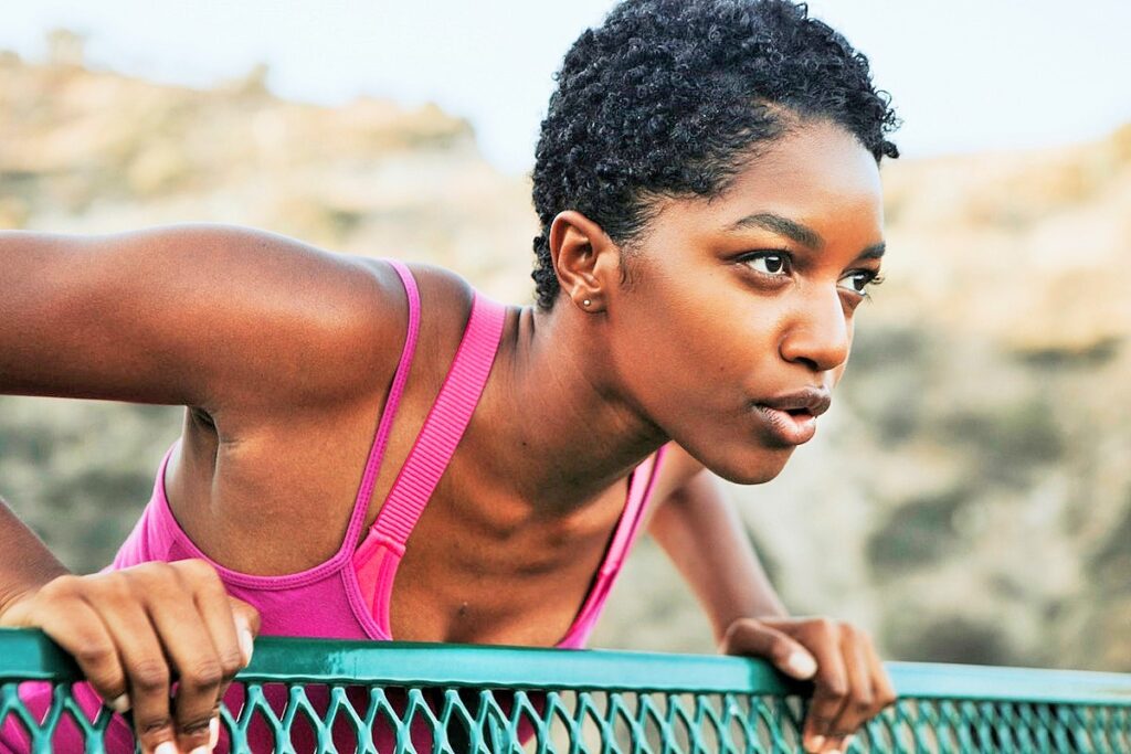 Focused woman preparing for workout in outdoor gym setting