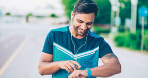 Man smiling while checking smartwatch