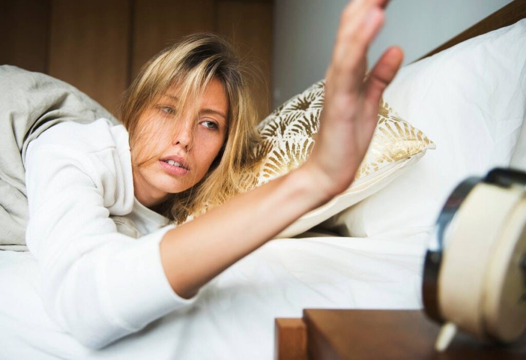 Woman resting in bed early in the morning after good night’s sleep