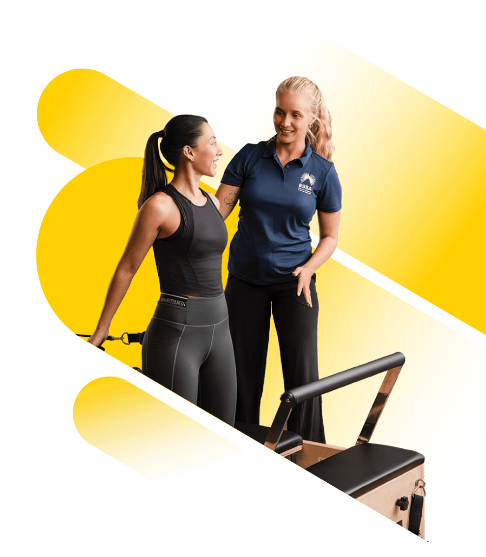Exercise professional guiding client on pilates reformer